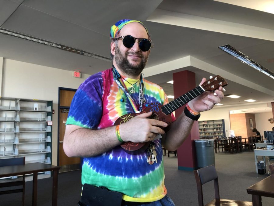 Mr. Newhouse plays the ukulele in the library. This year, he hopes to expand the resources available in the library.