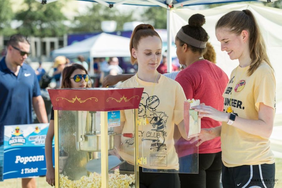 Key clubbers, Lauren and Olivia, working the popcorn machine during the Duck Race
