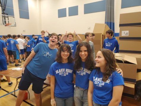 Blake and Jesuit Key Clubbers are all smiles as they work together to box about 7,000 barbecue chicken dinners for charity. Despite arriving at 2:00 am and working for over seven hours, the energy was still high as the students worked together to make a difference