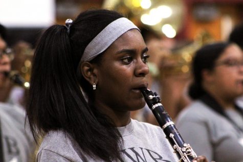 Band student plays the clarinet during the pep room to a full room of excited members of the Blake community. By: Cydney Socias